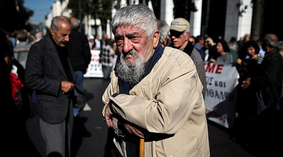 Click to enlarge Greek pensioner leans on a shepherd's crook at protest pension cuts athens