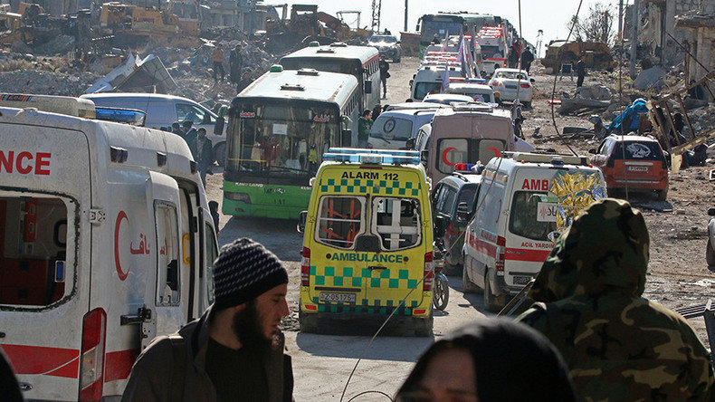 Ambulances and buses wait as they evacuate people from a rebel-held sector of eastern Aleppo