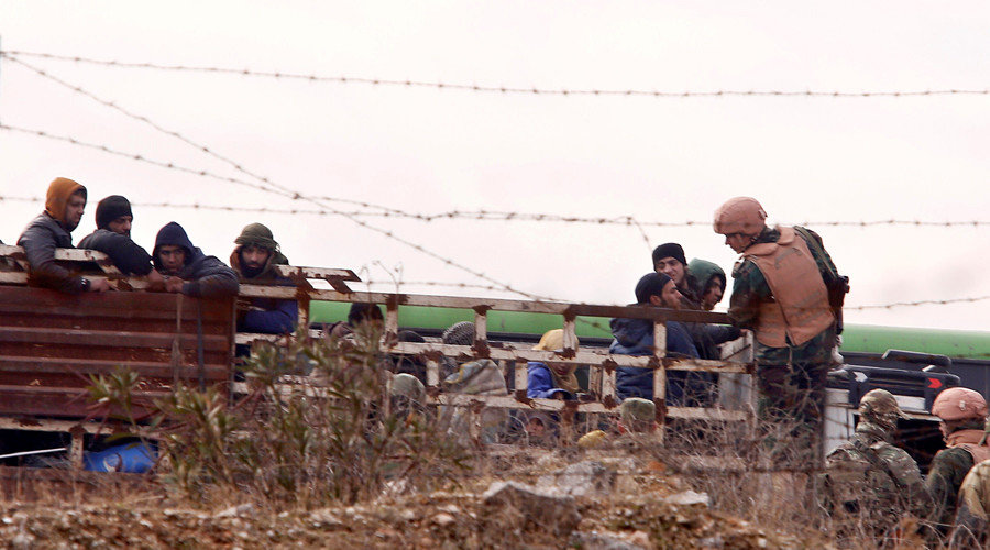 Click to enlarge Russian soldiers inspect rebels and civilians who were evacuated from rebel-held eastern Aleppo