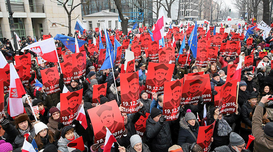 People hold signs with the image of Andrzej Rzeplinski