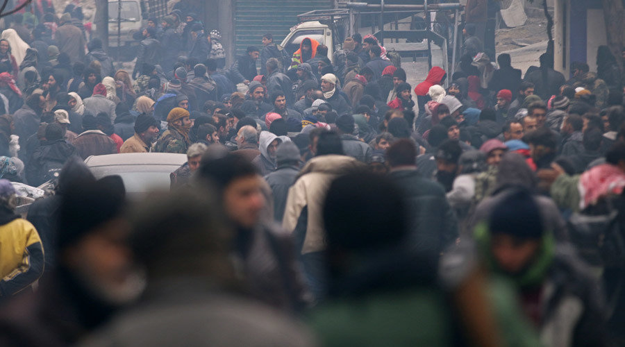 Click to enlarge Rebel fighters and civilians wait to be evacuated from a rebel-held sector of eastern Aleppo