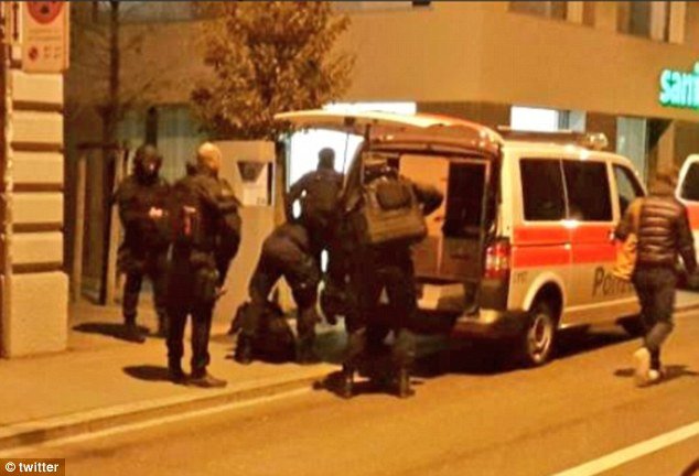 Heavily-armed police arrived at the scene, pictured, and began searching for the gunman