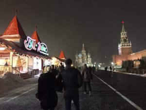 Red Square in Moscow with a winter festival to the left and the Kremlin to the right