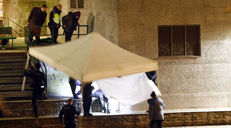 Police cover a body after a shooting outside an Islamic center in central Zurich, Switzerland December 19, 2016