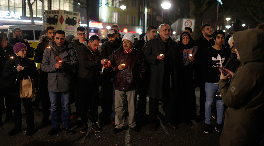 Refugees and asylum seekers hold candles
