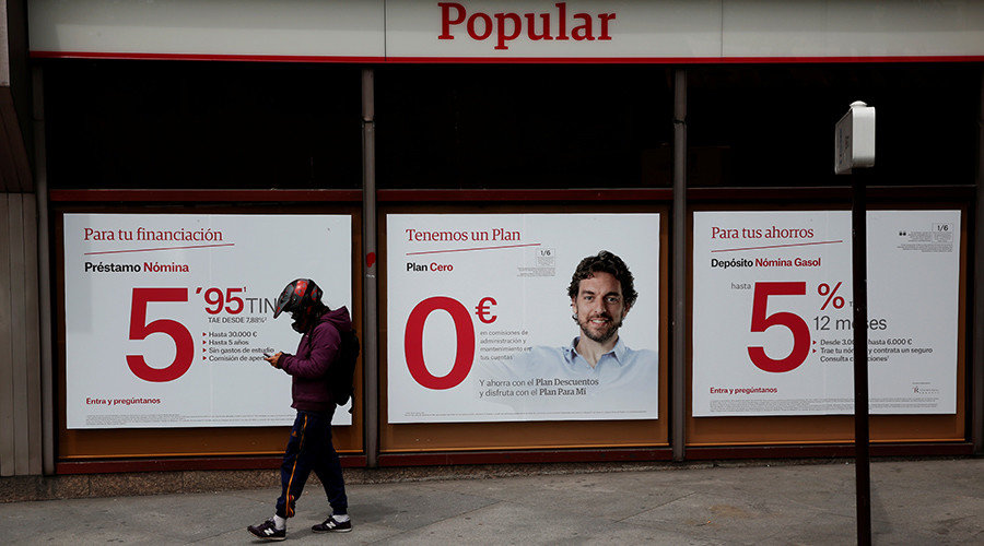 Person walking in front of Spanish bank