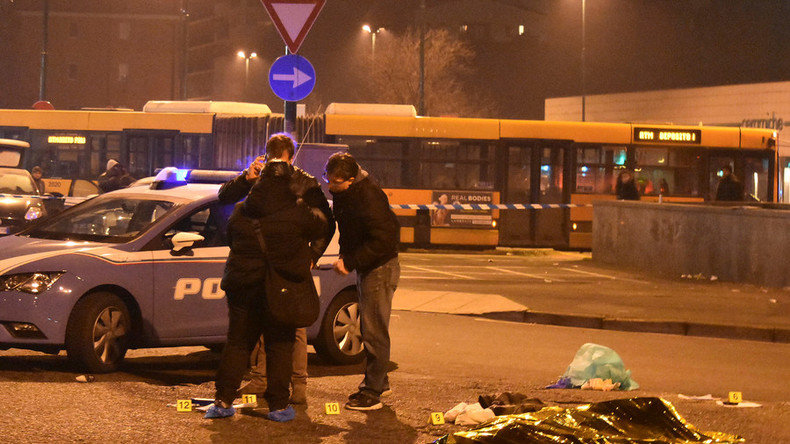 Click to enlarge Italian Police officers work next to the body of Anis Amri
