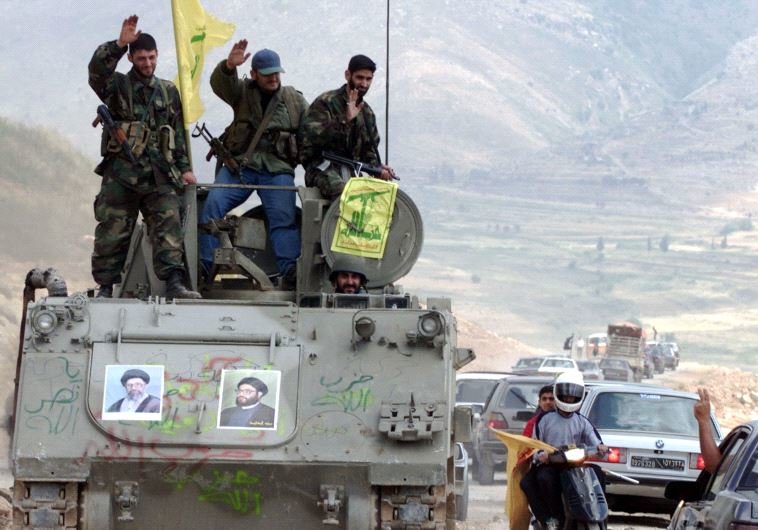 Hezbollah guerrillas, riding on an APC M113