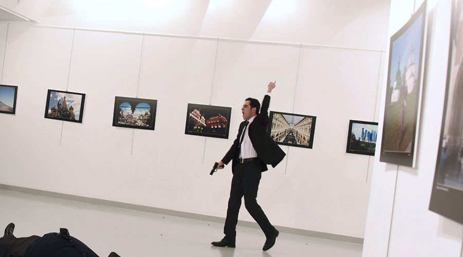 Andrei Karlov, the Russian ambassador to Ankara, lying on the floor after being shot by Mevlut Mert Altintas (R) during an attack during a public event in Ankara