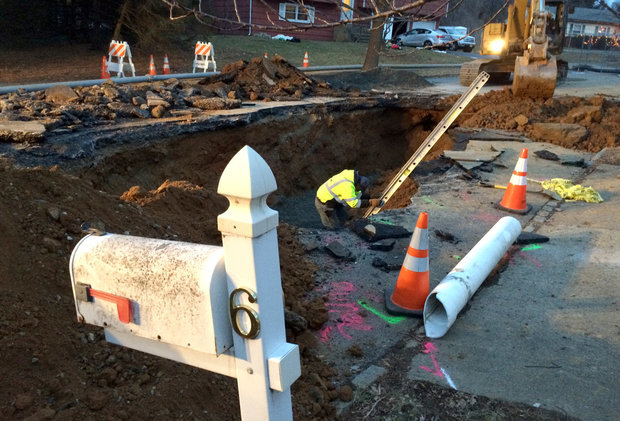 Click to enlarge A workers on Dec. 23, 2016, climbs down into to a large sinkhole that opened days earlier on Lopatcong Township's Wordsworth Lane, the same street where a snow plow was almost swallowed by a sinkhole in 2015