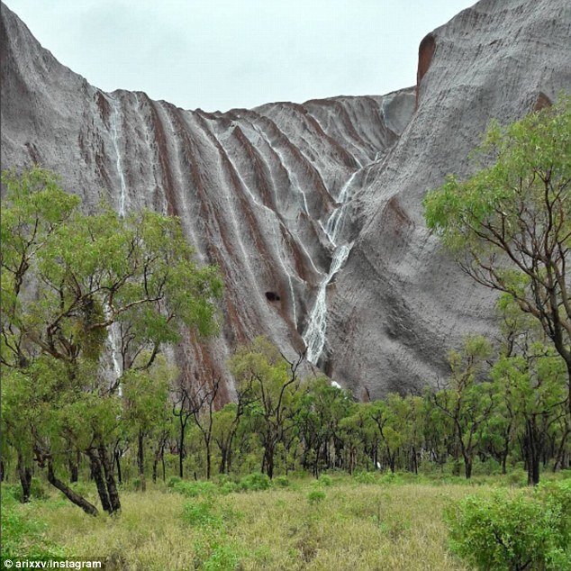 Water begins to trickle down the side of the massive rock