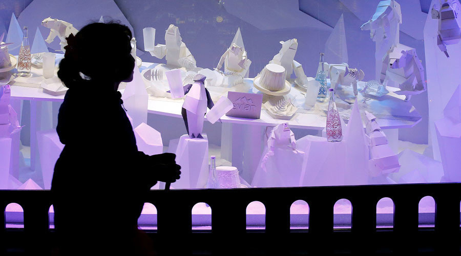 Child walking past store display
