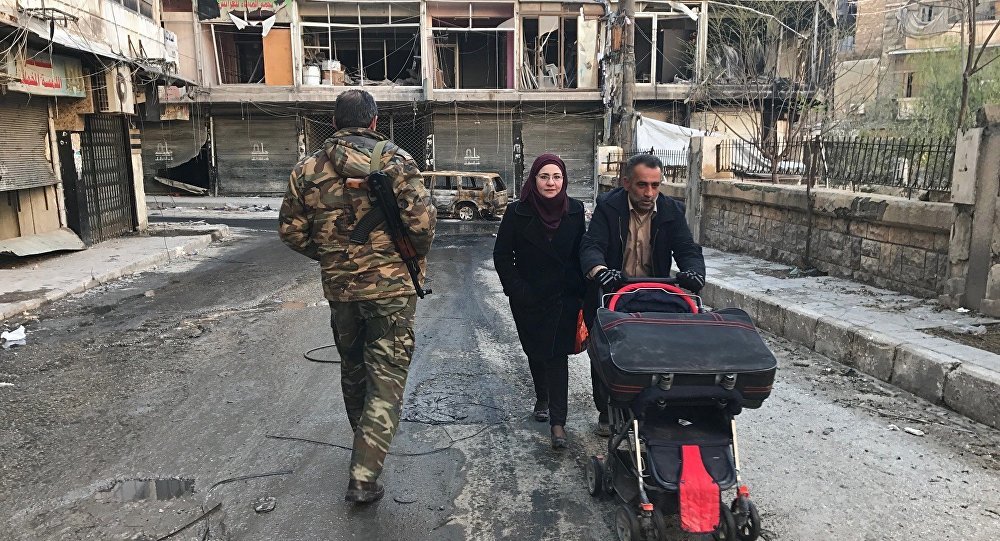Residents in a liberated neighborhood of eastern Aleppo in Syria