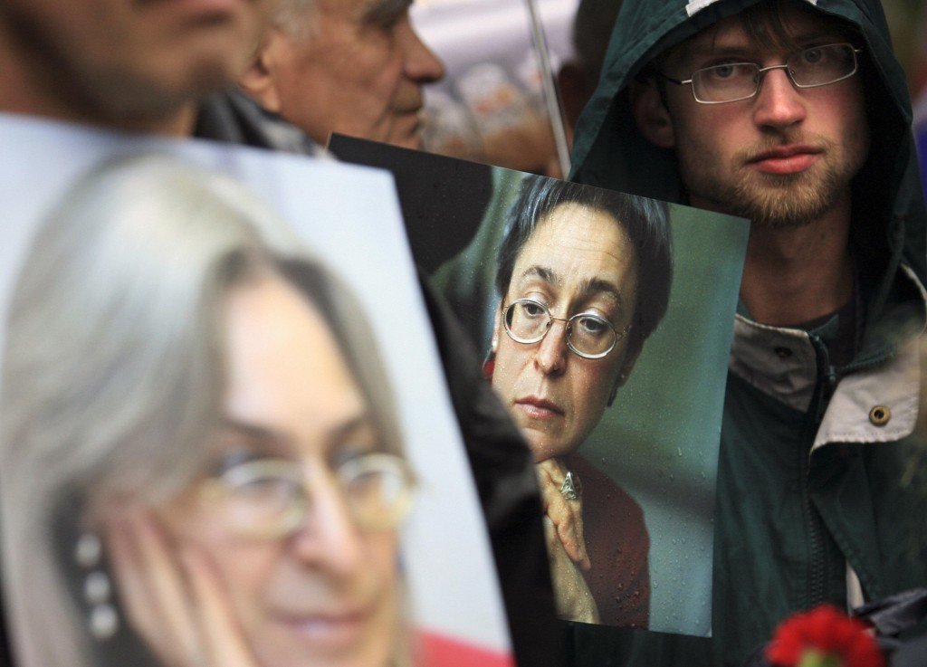 People hold pictures of Russian journalist Anna Politkovskaya during a rally in central Moscow on 