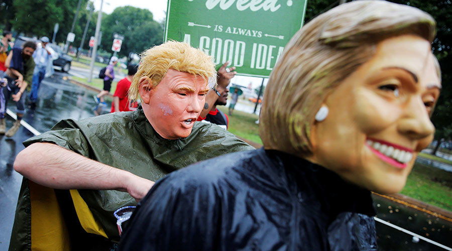 Protesters wearing masks of presidential candidates Hillary Clinton and Donald Trump