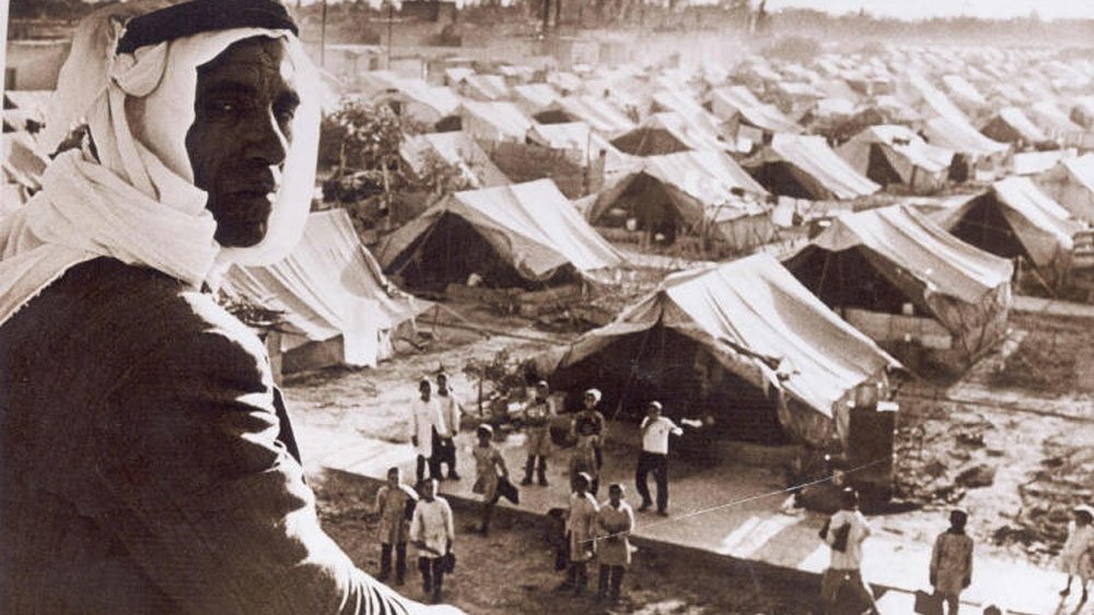 A Palestinian man sits in a refugee camp following the displacement in Nakba