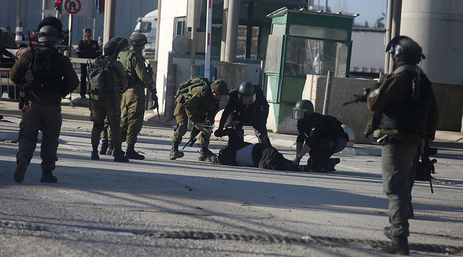 Click to enlarge Israeli security forces tend to a Palestinian woman