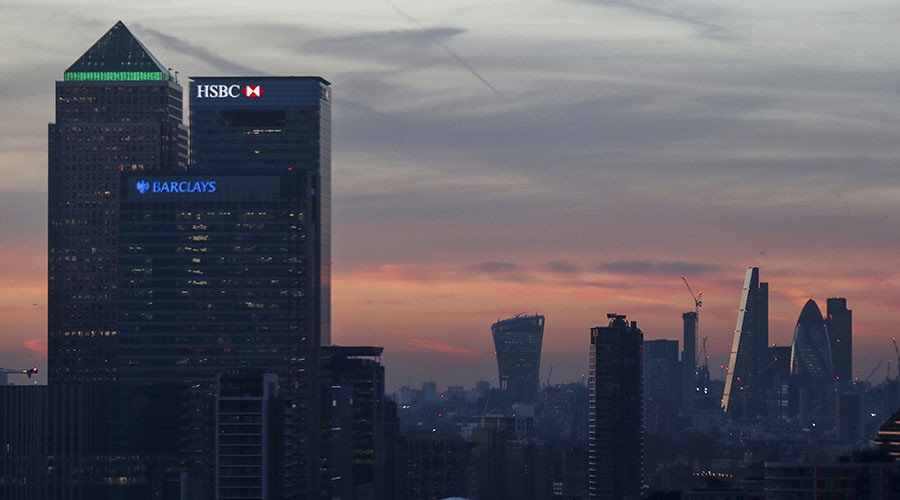 Canary Wharf and the city are seen at sunset in London