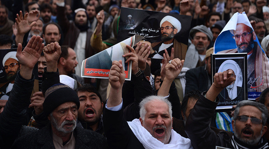 Afghan Shiites hold posters and chant slogans during a demonstration in Herat on January 3, 2017