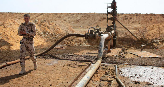 Turkey soldier inspects the Jazal oil field following battles with Daesh