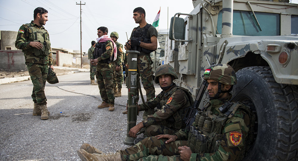 Click to enlarge Iraqi Kurdish Peshmerga fighters rest next to their vehicles after returning from combat against Islamic State (IS) group jihadists in Bashiqa on November 9, 2016