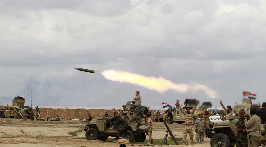 Click to enlarge Shi'ite fighters launch rocket towards Islamic State militants during heavy fighting in Salahuddin province