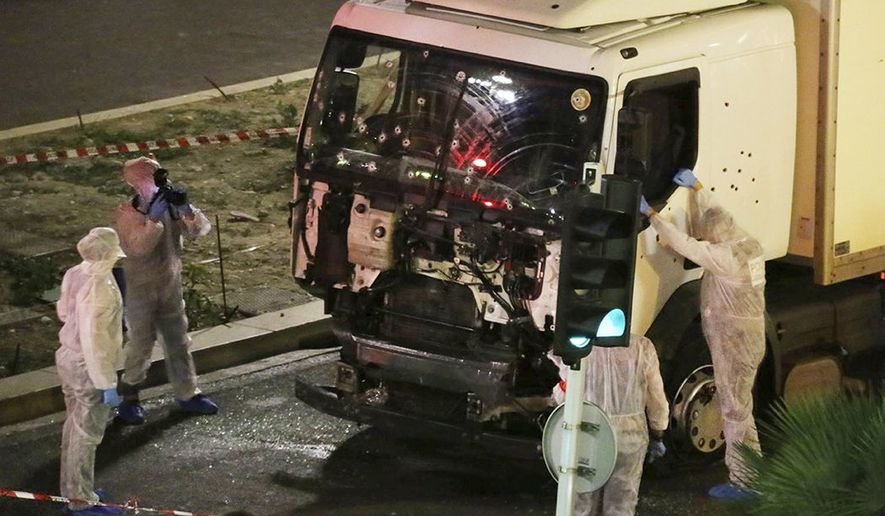 Click to enlarge Authorities investigate a truck after it plowed through Bastille Day revelers in French resort city of Nice