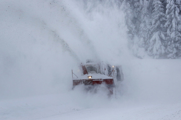 Bosnian worker tries to clear a mountain road near Sarajevo, Bosnia, on Friday, Jan. 6, 2017. The region is bracing itself for a spell of extremely cold weather with temperatures expected to remain between - 11 and - 26 degrees centigrade (from 5 to - 14.