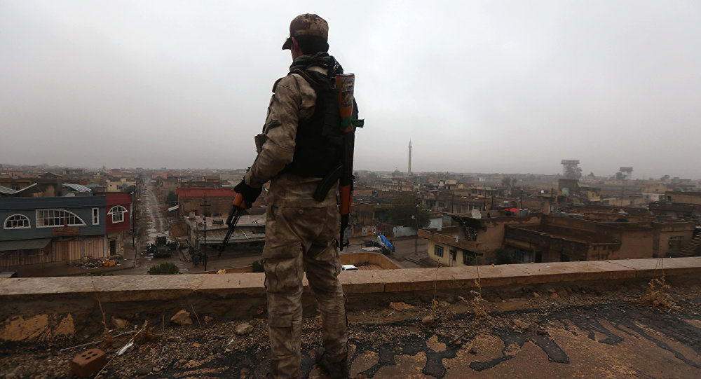 An Iraqi security member stands guard as Iraqi Christians attend a Christmas Eve at the Saint John's church (Mar Yohanna church) in the town of Qaraqosh (also known as Hamdaniya), 30 km east of Mosul, on December 25, 2016