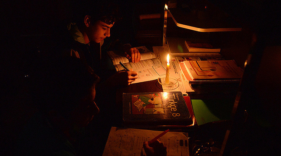 Click to enlarge Power cut means reading by candle