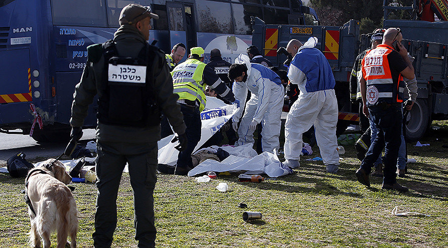 Click to enlarge Israeli security forces stand guard as medics cover bodies at the site of a ramming attack in Jerusalem