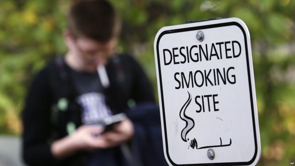 College student smoking and on phone