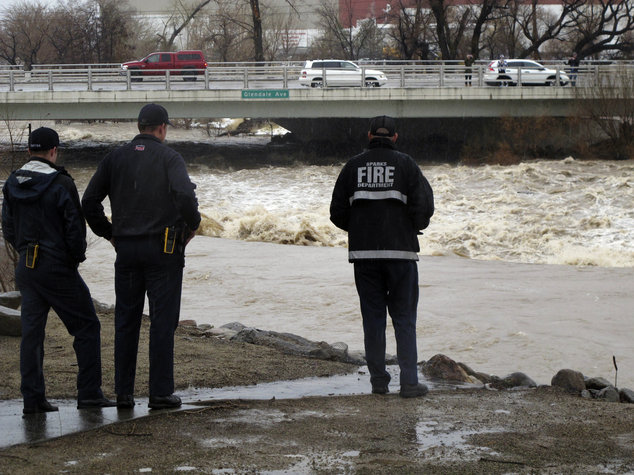 Click to enlarge Sparks firefighters monitor the rising Truckee River, Sunday, Jan. 8, 2017, where it runs near the Grand Sierra hotel-casino along a line that divides the cities of Reno and Sparks, Nev.