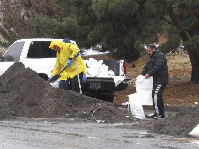 Click to enlarge Local residents braved the heavy rain to fill sandbags on Sunday, Jan. 8, 2017, near the Truckee River in Sparks, Nev.