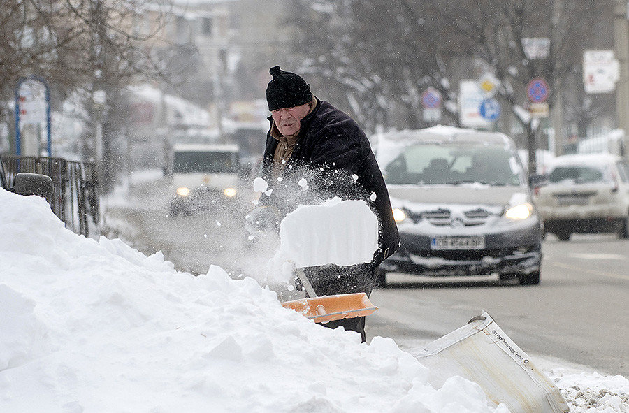 Click to enlarge Man shoveling snow