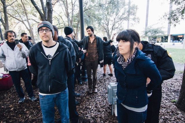 Click to enlarge Two activists with Food Not Bombs are handcuffed after they defied police orders to stop feeding the homeless in a downtown Tampa public park.