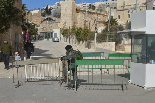 Click to enlarge Israeli soldier guards a checkpoint