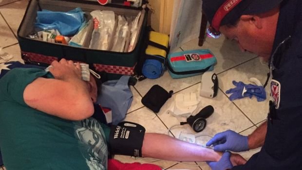 Click to enlarge Paramedics treat Mr Chenhall.