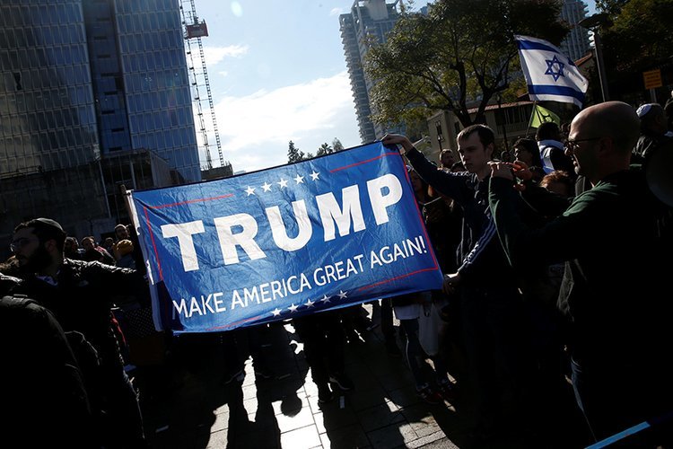 Click to enlarge Azaria supporters hold Trump flag