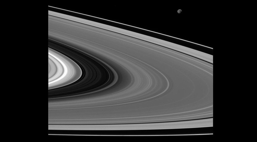 Mimas (upper right) lit by light reflected off of Saturn
