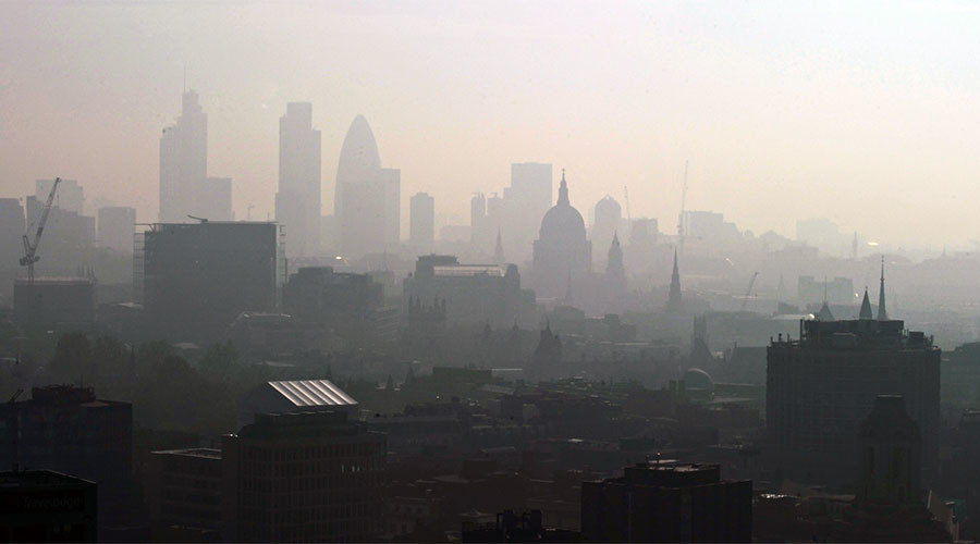 St. Paul's Cathedral is seen in the early morning sunlight among the skyline through the smog in central London