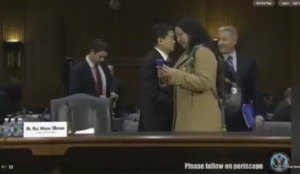 Unknown reporter capturing Tillerson's notes