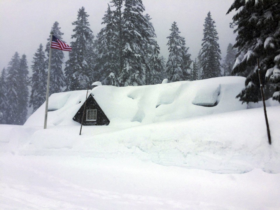 Click to enlarge This Tuesday, Jan. 10, 2017 photo provided by the U.S. National Park Service shows the Crater Lake National Park visitor center in Oregon buried in snow up to the eaves as severe weather forced the southern Oregon park's closure.