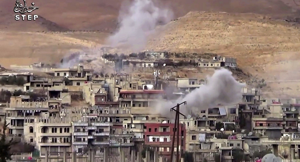 Smoke rises from a building in Wadi Barada, Syria