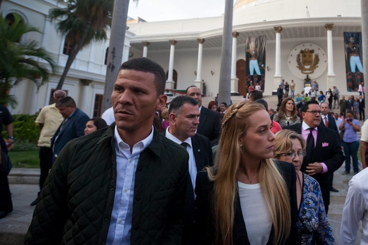 Legislator Gilber Caro, left, walked next to human-rights activist Lilian Tintori, the wife of Venezuelan oppostiion leader Leopoldo López, outside the National Assembly, in Caracas on Jan. 11, 2016. Intelligence police arrested Mr. Caro on Wednesday