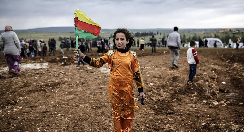 Young Syrian Kurdish woman holding flag