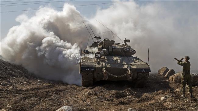 Israeli soldier directs a Merkava tank