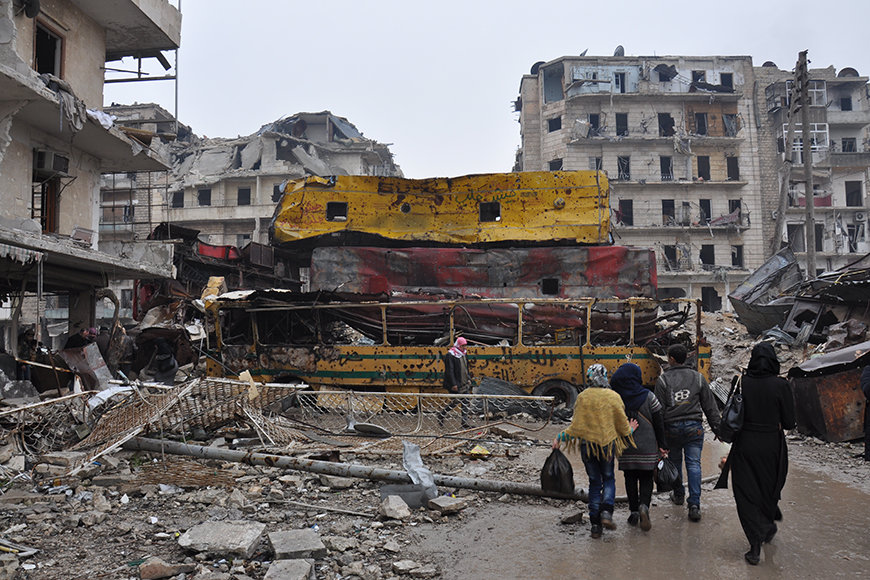 Overturned buses are used as barriers in Aleppo's Bustan al-Qasr neighborhood