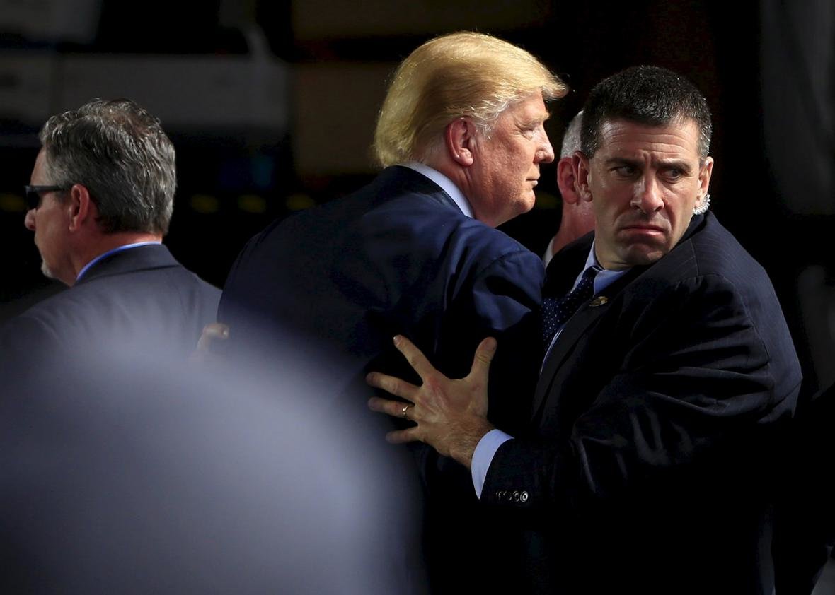 Secret Service agents surround Republican presidential candidate Donald Trump during a disturbance as he speaks at Dayton International Airport in Dayton, Ohio