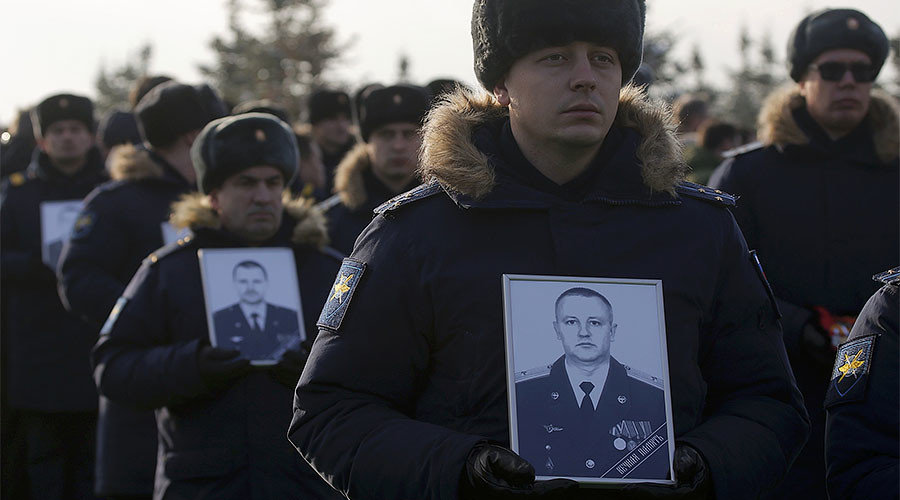Servicemen take part in a memorial ceremony